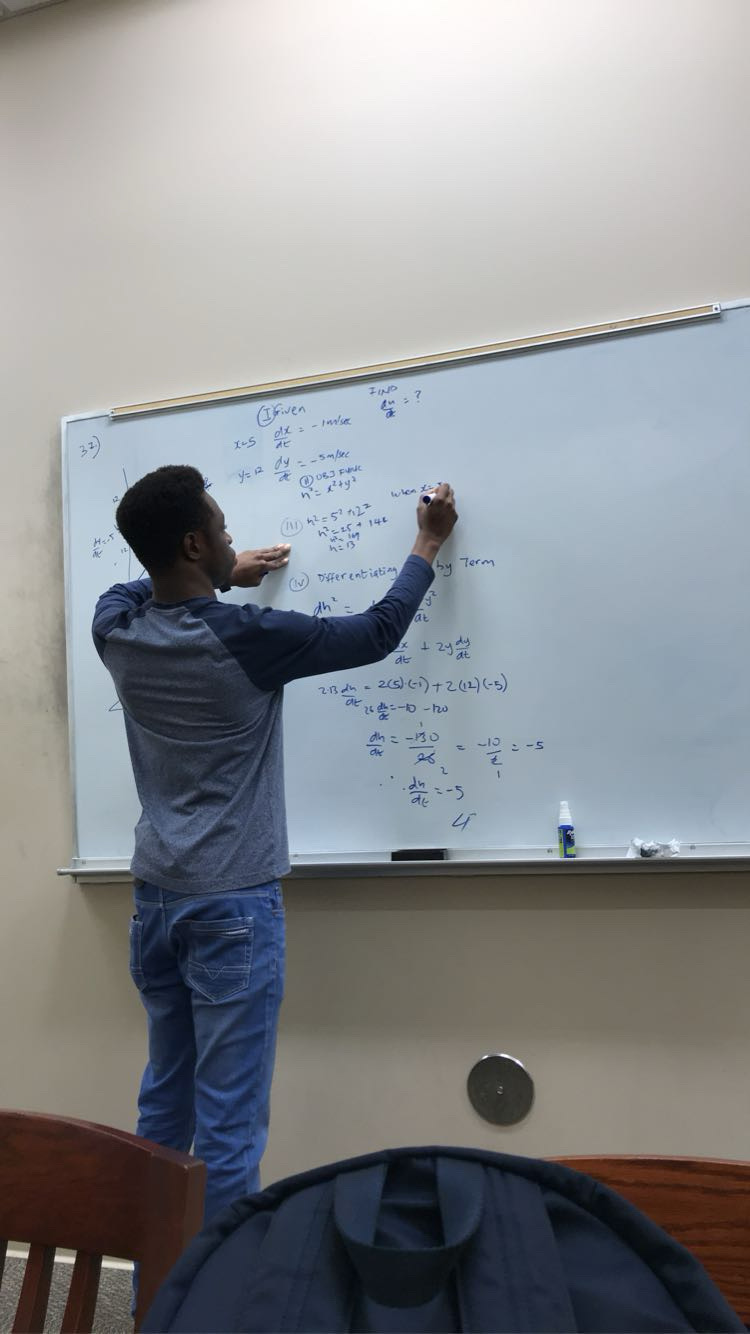 Sam teaching Math on Whiteboard in 2020